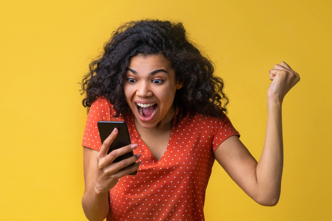 Excited woman looking at her phone